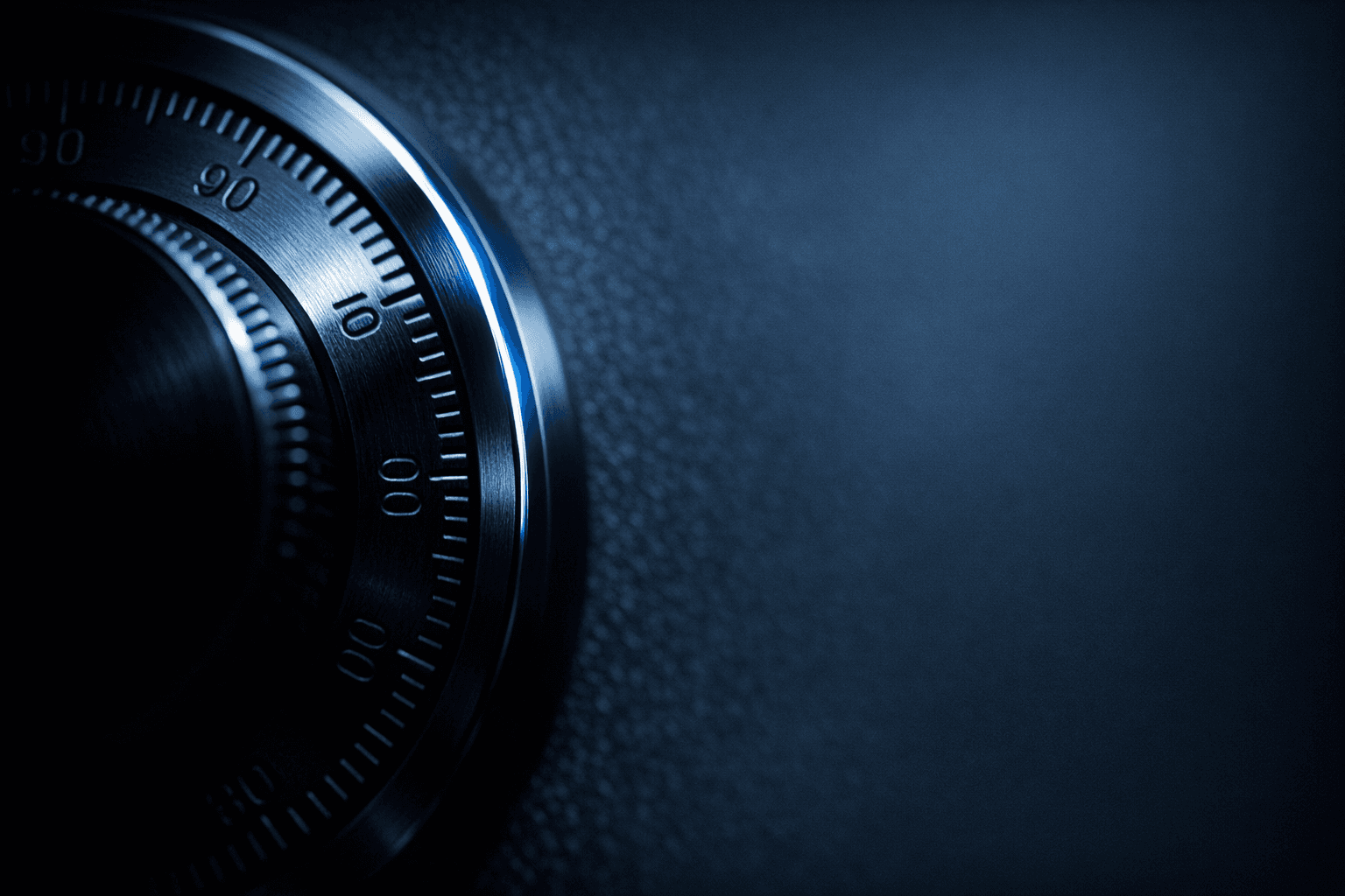 A macro shot of a vault dial rendered in blue-steel tones